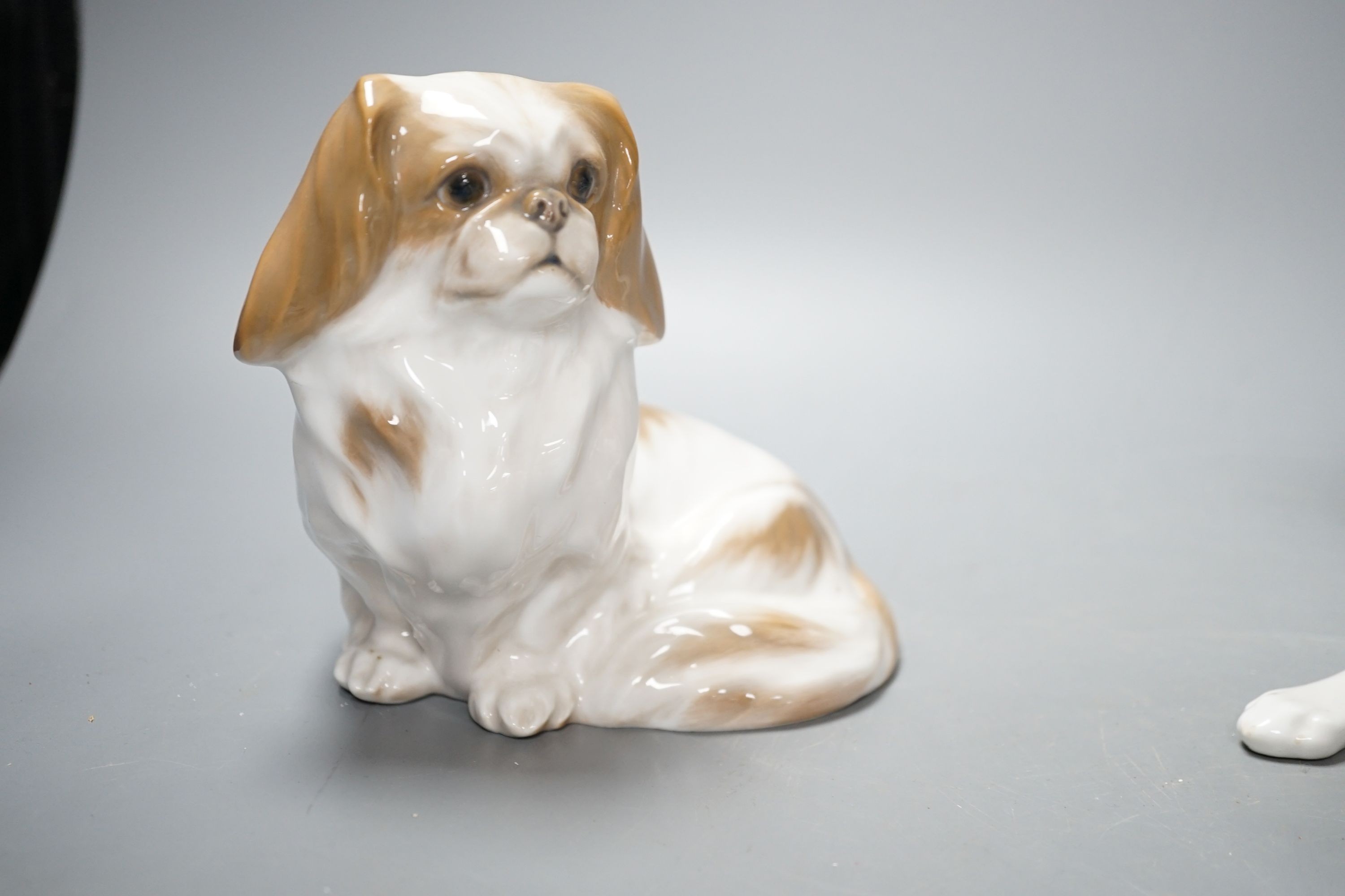 Two Royal Copenhagen figures of dogs and two Bing and Grondahl figures of dogs, largest 23 cms wide
